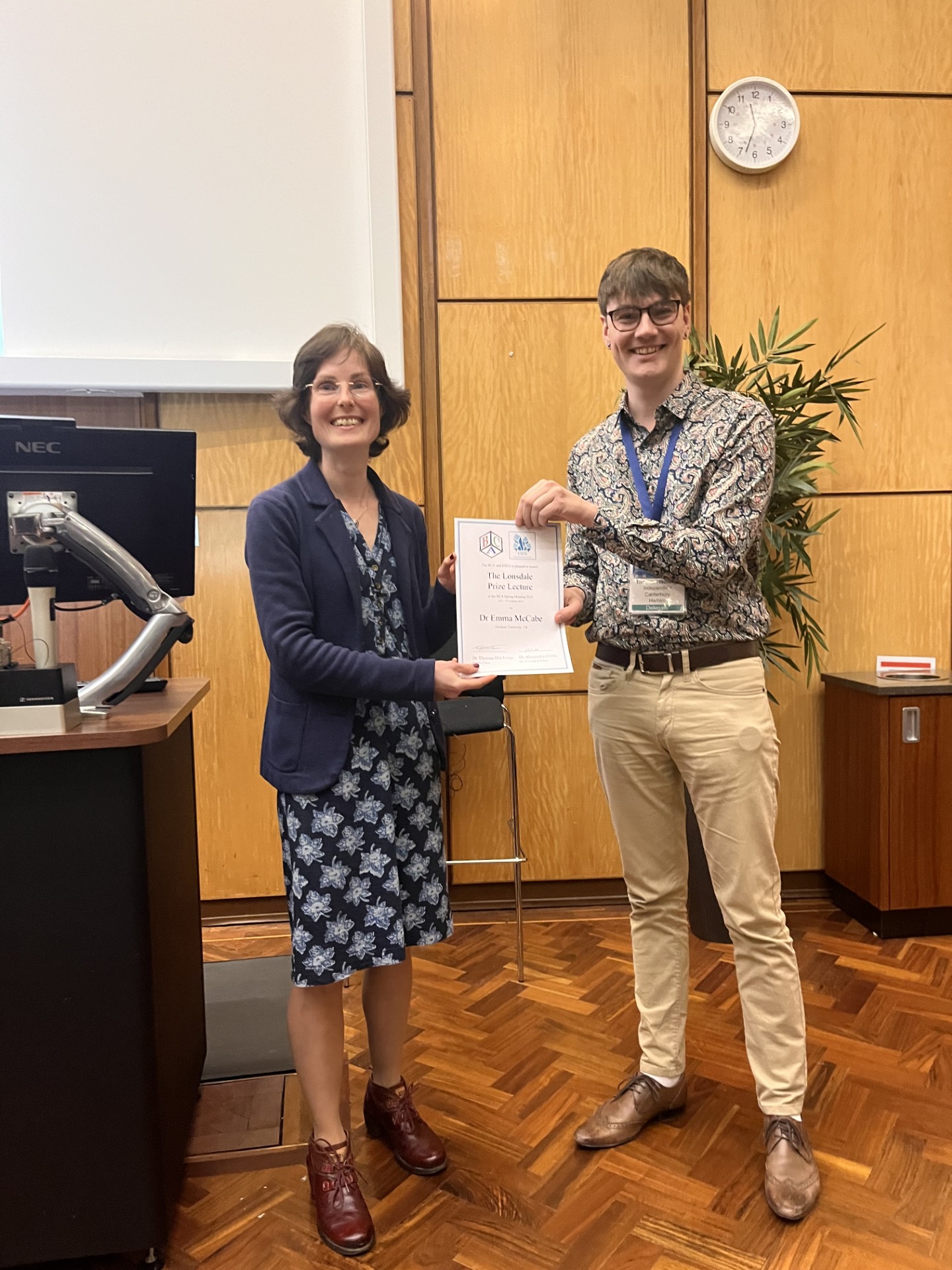 Dr Emma McCabe receives her prize from Dr Tom Hitchings