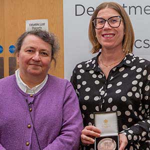 Photograph of Lorraine receiving his award, presented by Paula Chadwick