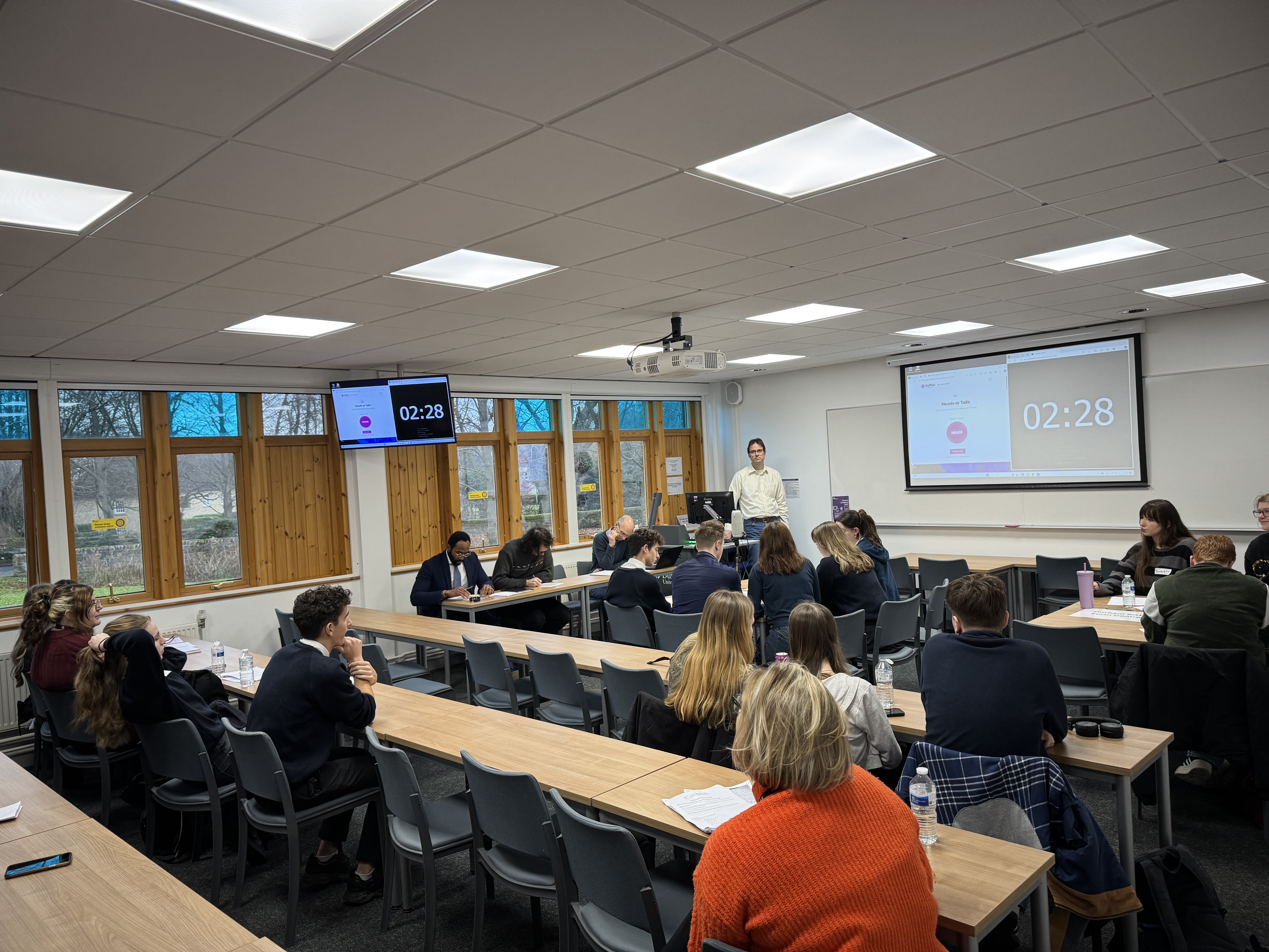 Groups of students sat at desks in discussions