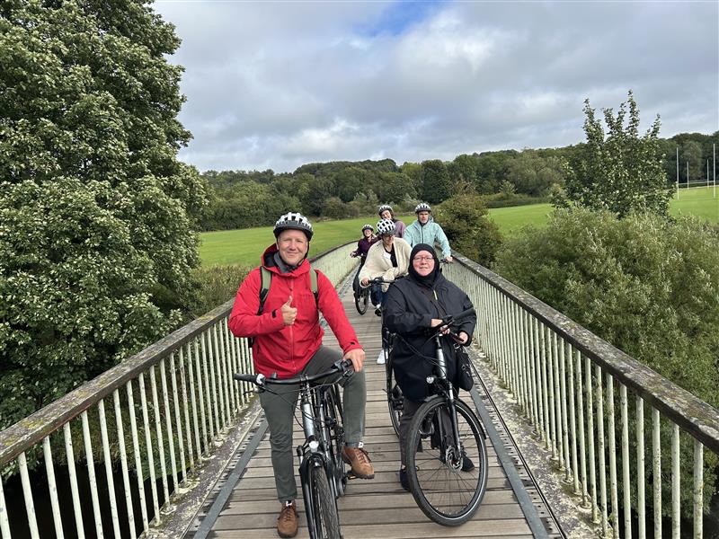 A group of cyclists posing for a picture