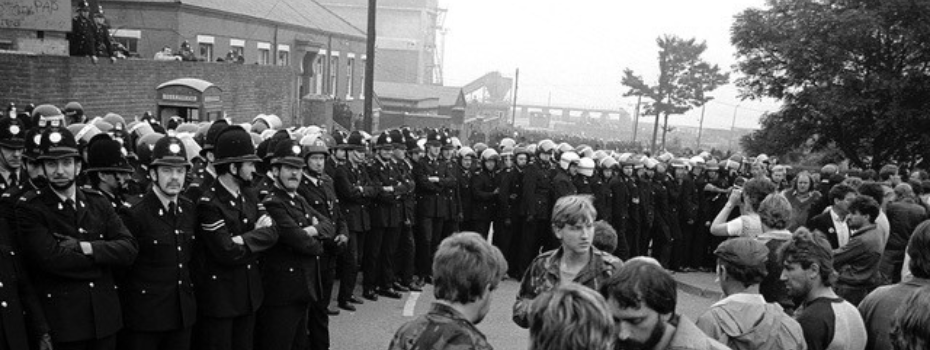 Black and white image of men in a mining village.