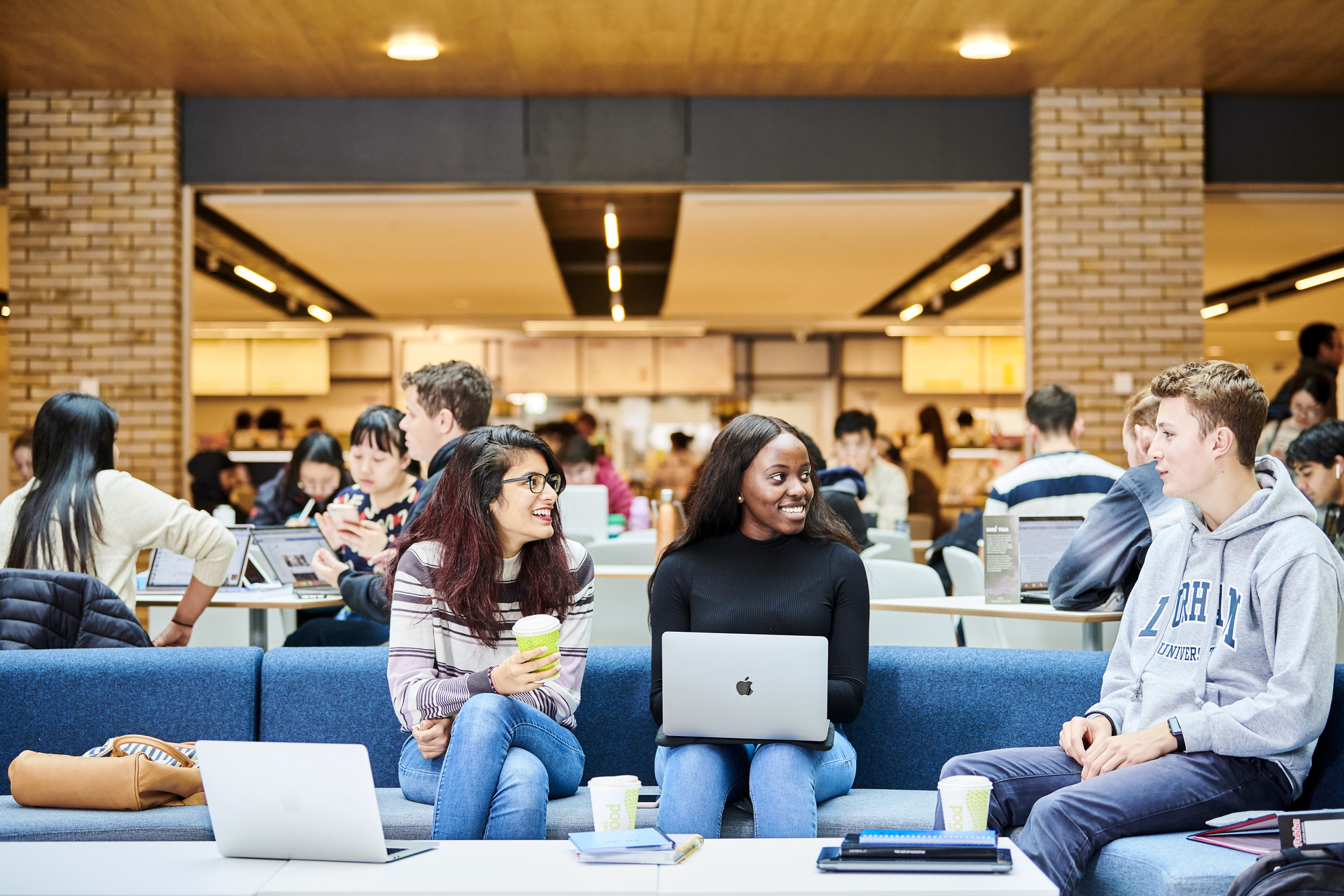 Students working on sofas in the Teaching and Learning Centre