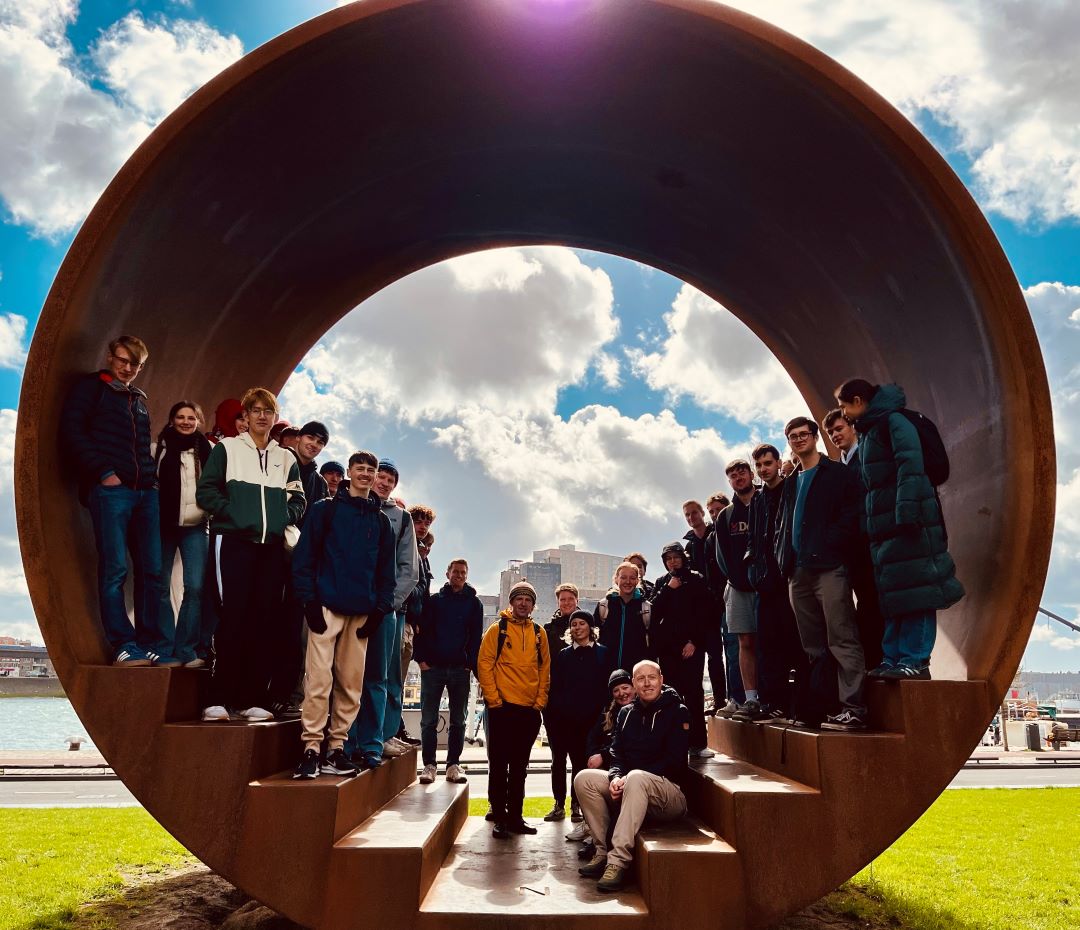 A group of Geography students standing inside a circular sculpture on a field trip to Rotterdam