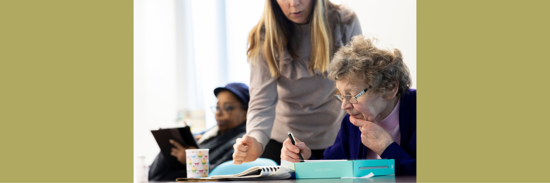A person being offered support by another person completing paperwork