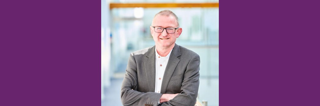 Professor Martin Evans is pictured in a brown jacket and white shirt in the Palatine Centre