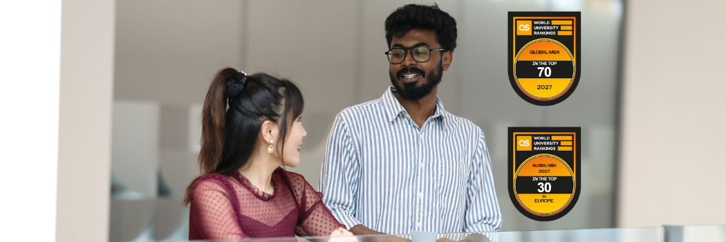 Two people talking against a blank background including QS logos