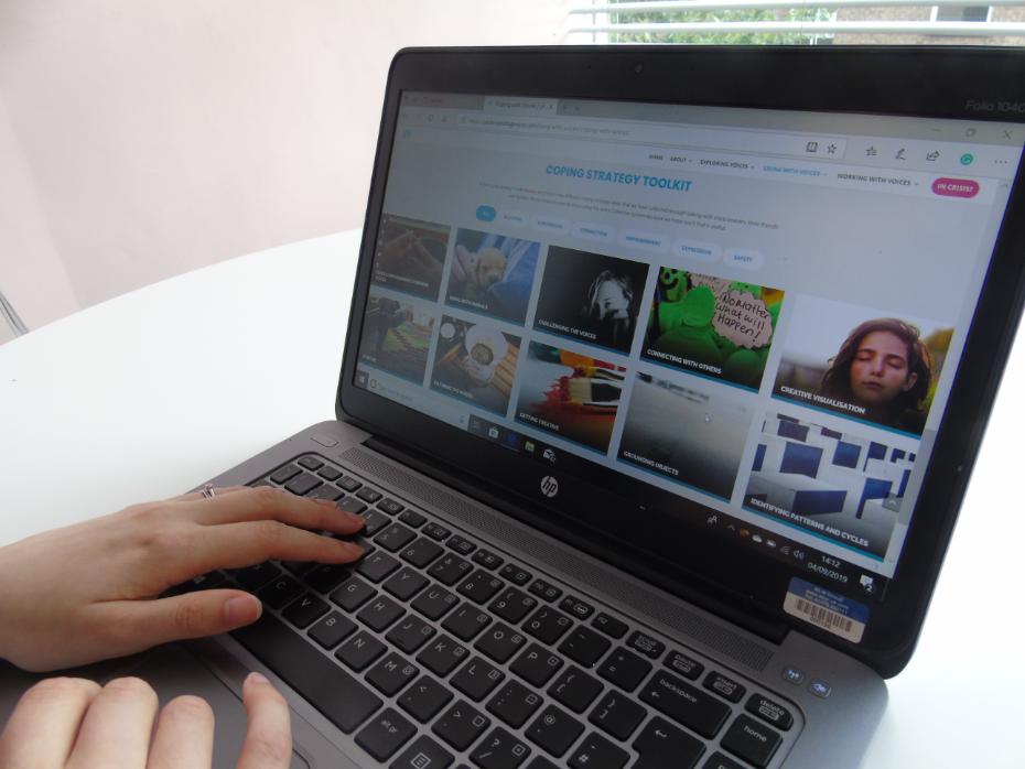 Close up of a woman working on a laptop