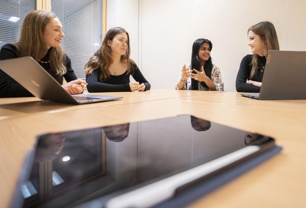 Interns sitting around a table