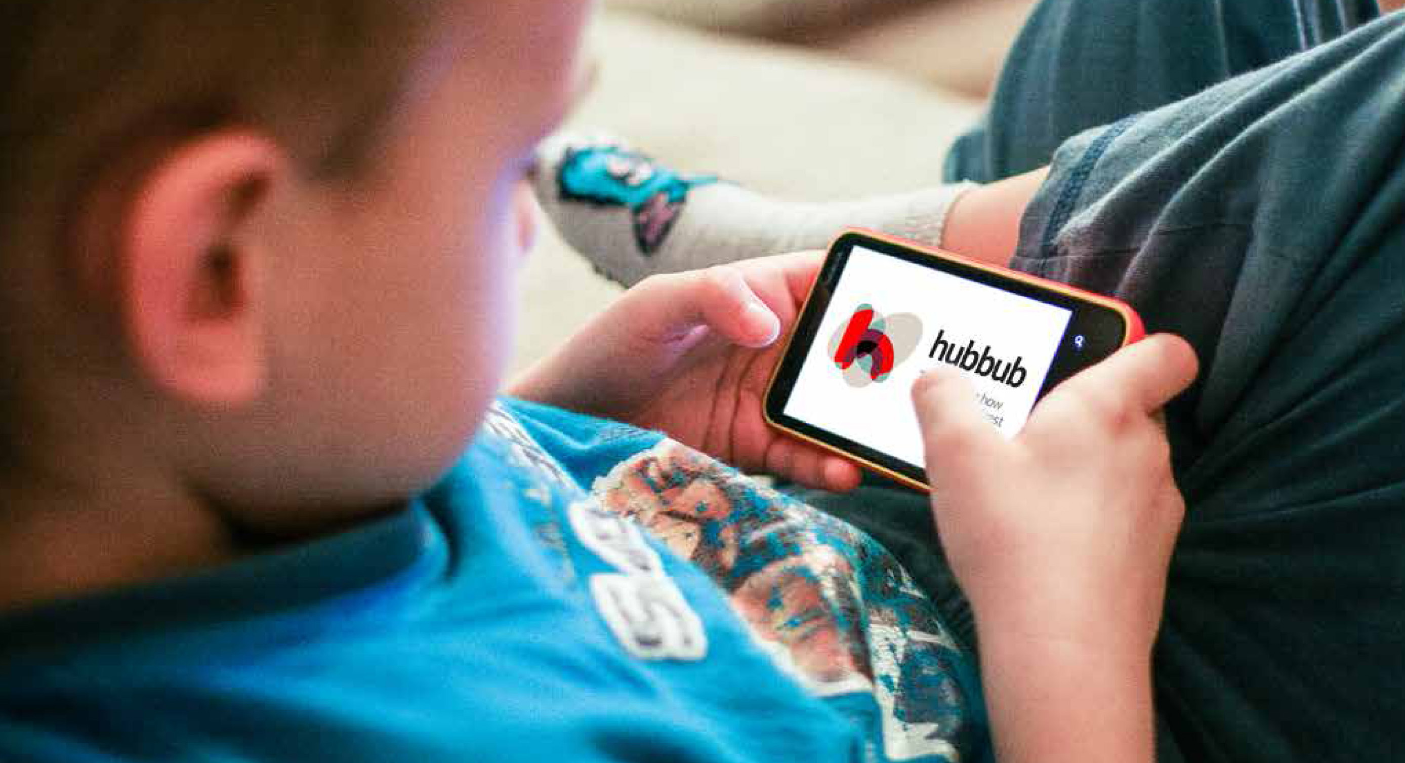 Child looking at the logo for Hubbub on a device