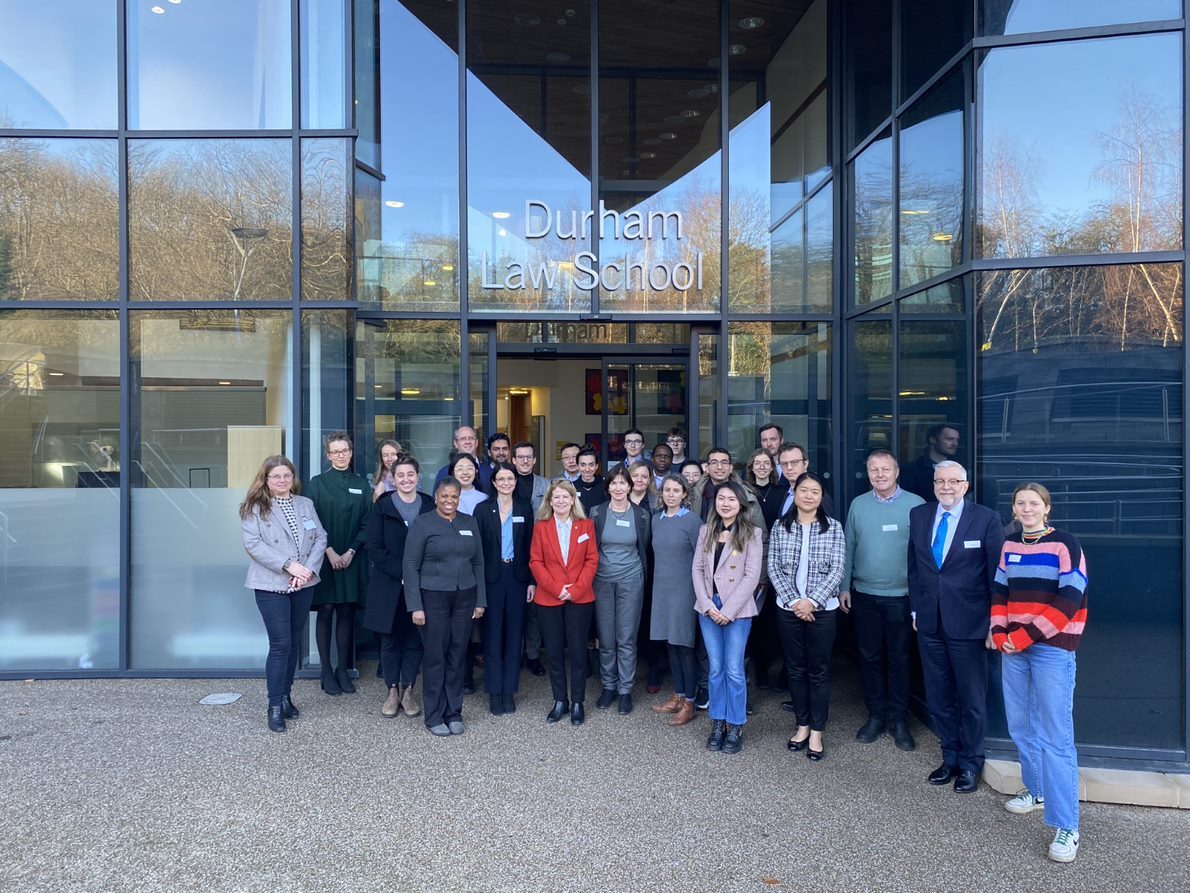 A group of people standing outside Durham law School