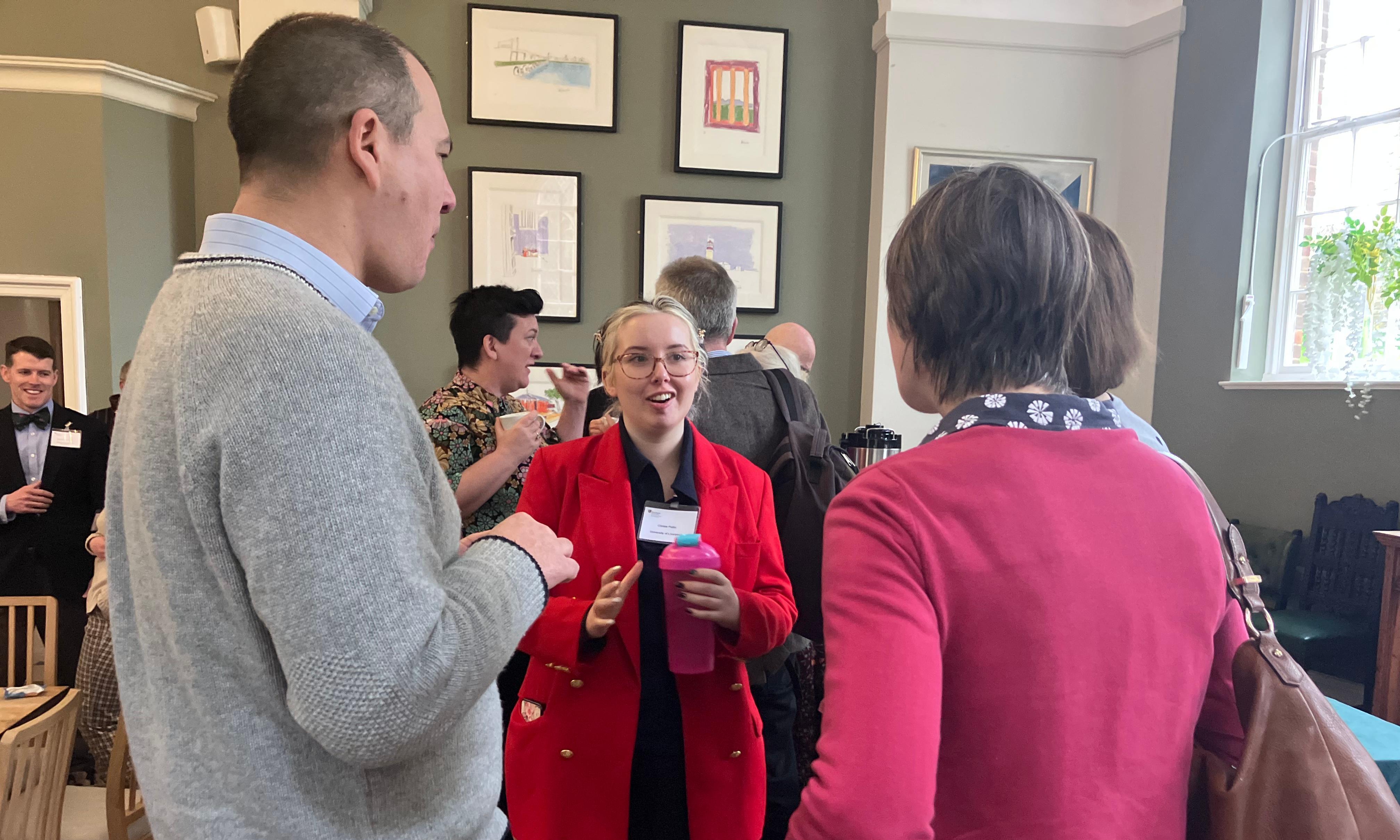 A group of people talking over cups of tea