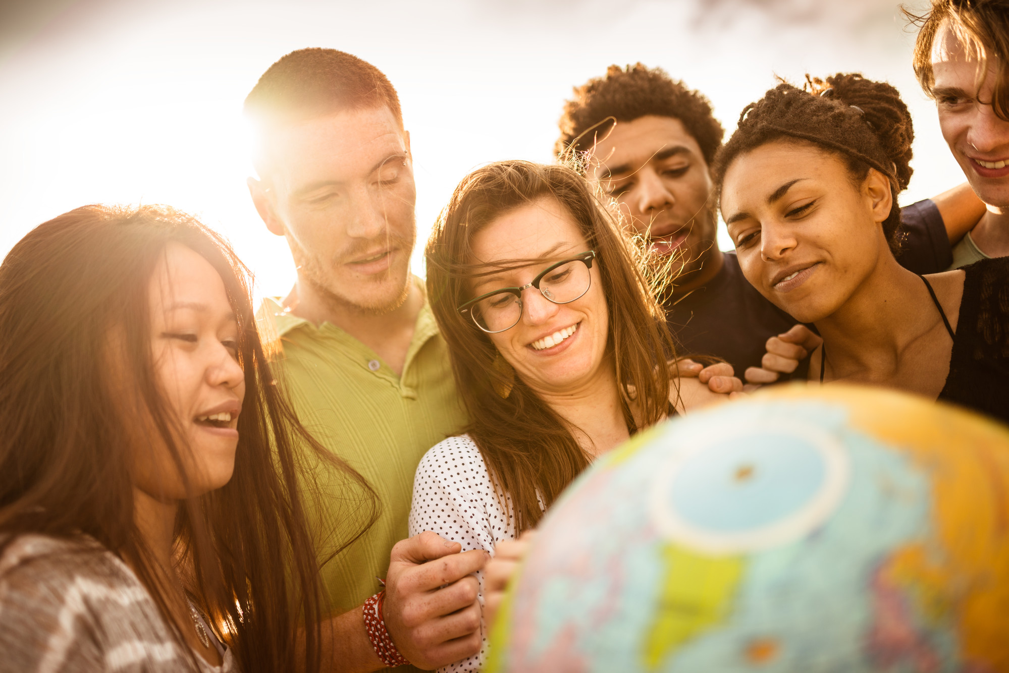 Group of people smiling with globe