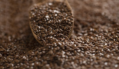 Brown flax seeds and wooden shovel_image courtesy of iStock
