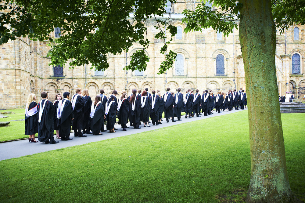 a group of graduates walking to the cathedral