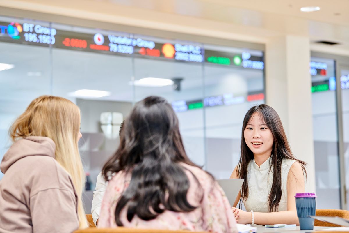students chatting at business school