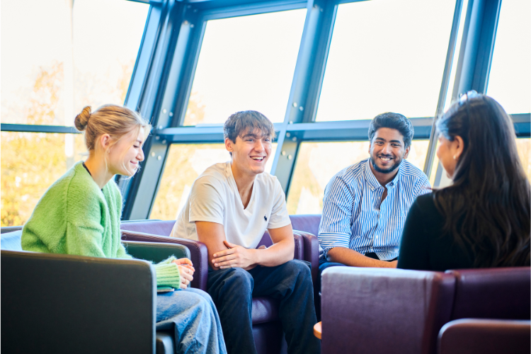 A group of students chatting on sofas