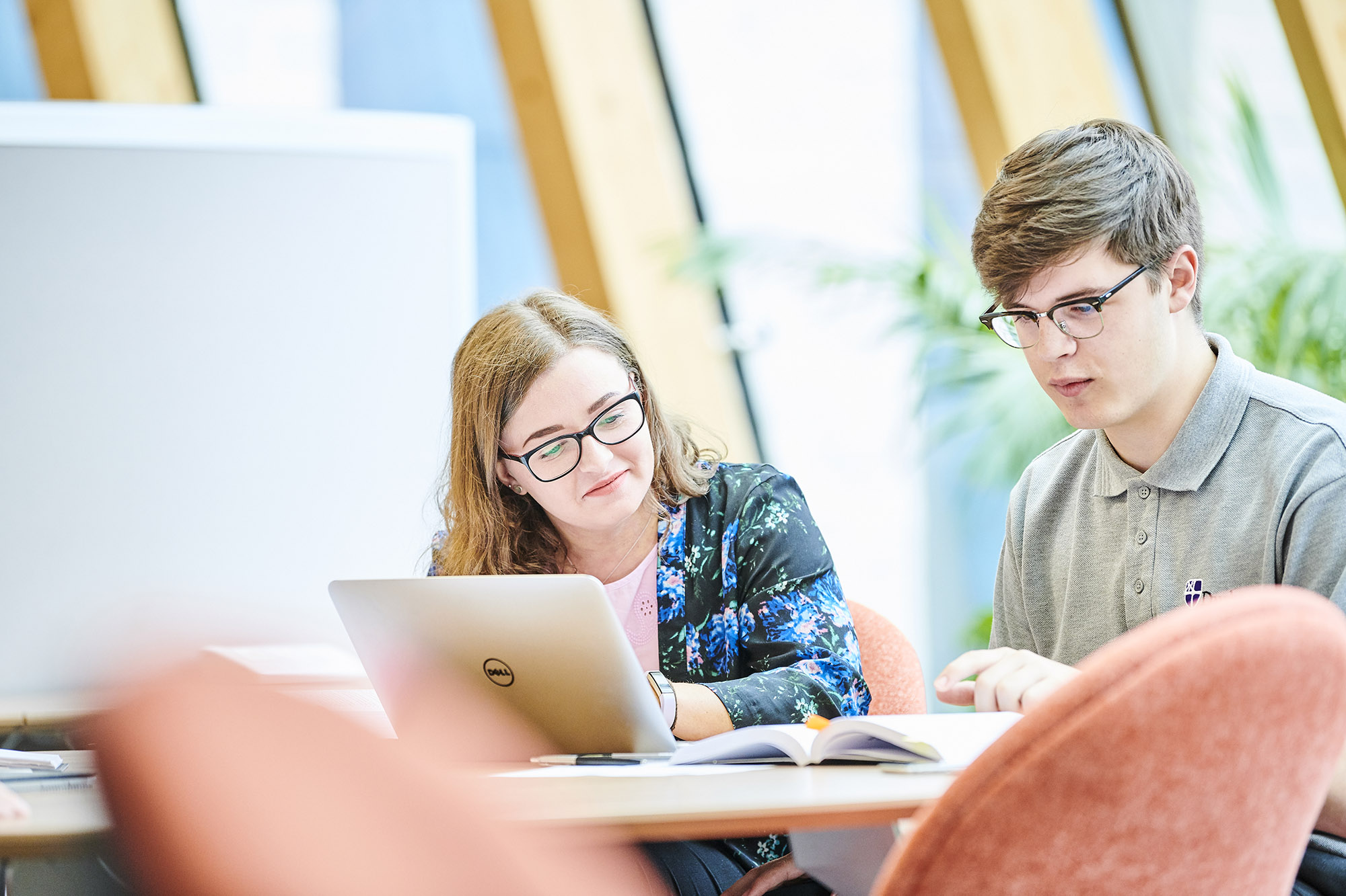 Two people looking at laptop
