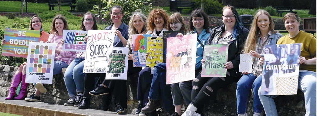 Members of Strike Women+ art collective, showing their artwork