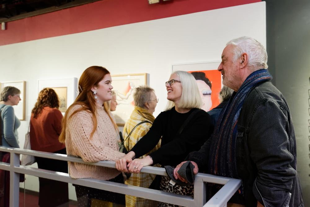 Three people talking while stood in the Oriental Museum
