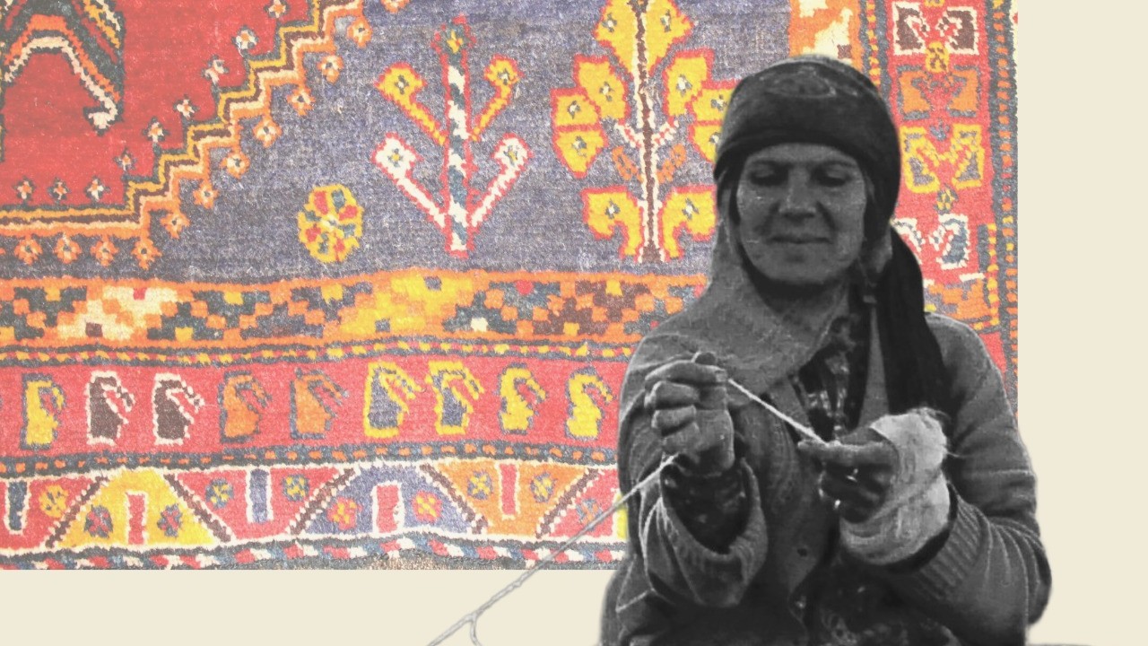 a black and white photo of a woman weaving, with a background of a colourful Iranian carpet